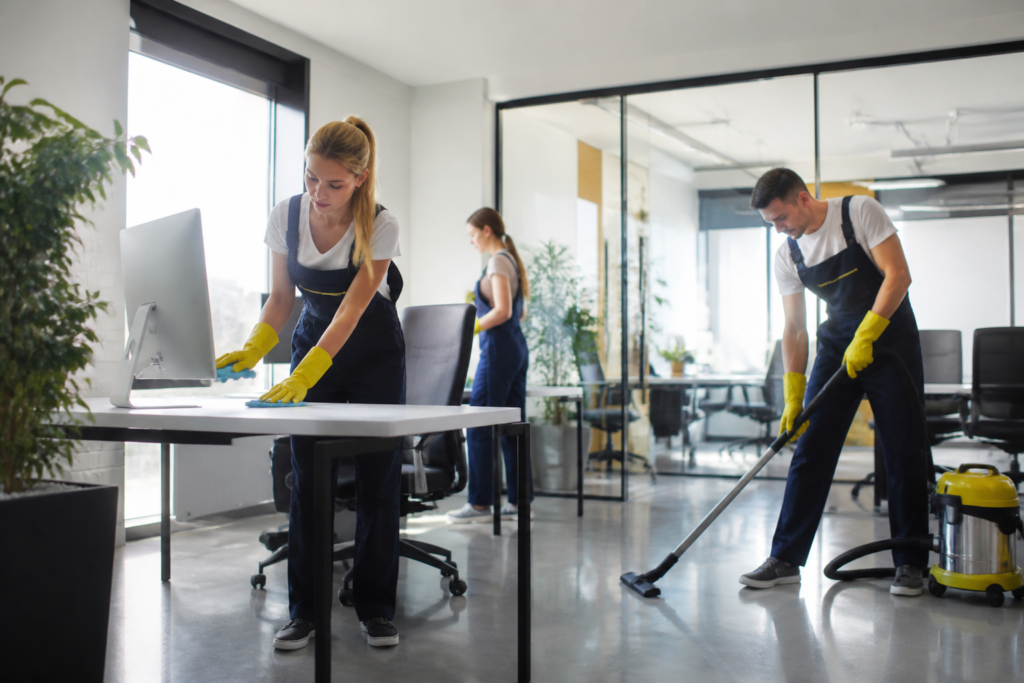 Commercial cleaning standards Jacksonville—Professional cleaner disinfecting office desk with spray and cloth in Jacksonville office